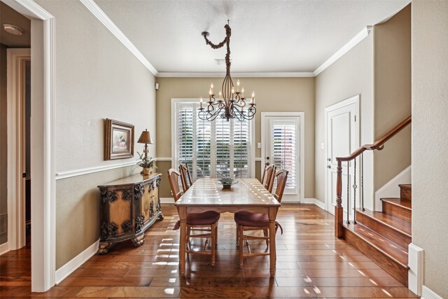 dining space with hardwood / wood-style floors, crown molding, and a wealth of natural light