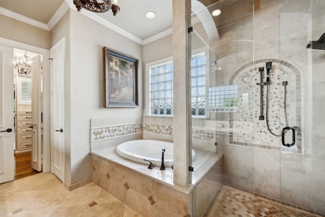 bathroom with a notable chandelier, separate shower and tub, and ornamental molding