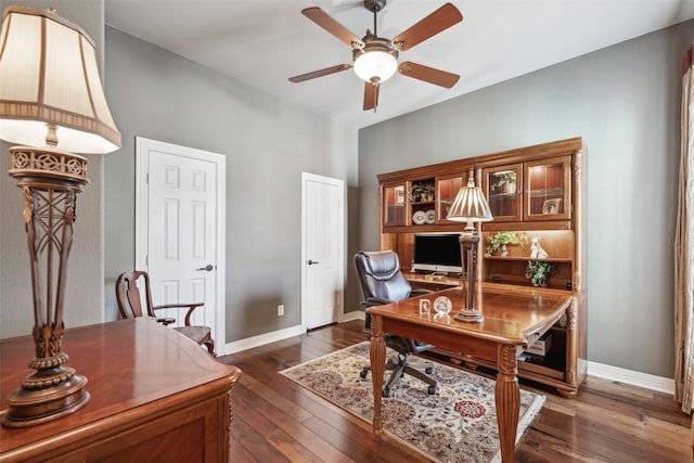 office space featuring ceiling fan and dark hardwood / wood-style flooring