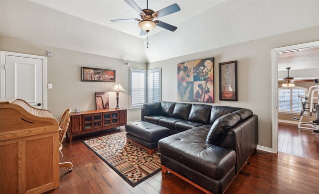 living room featuring a healthy amount of sunlight, dark hardwood / wood-style flooring, and lofted ceiling