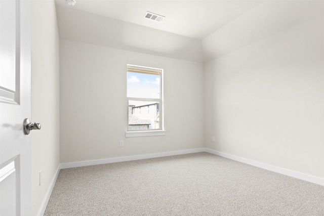 carpeted spare room featuring visible vents and baseboards