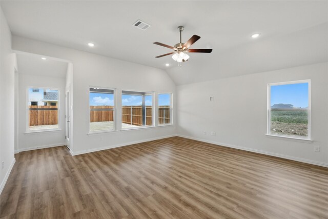 unfurnished living room with recessed lighting, visible vents, plenty of natural light, and wood finished floors