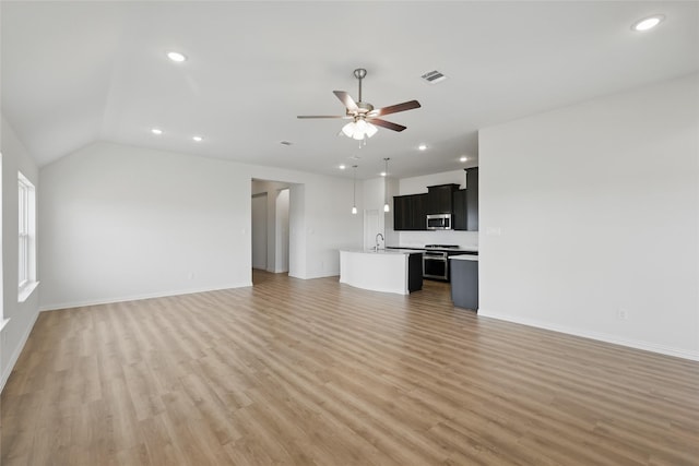 unfurnished living room featuring visible vents, a ceiling fan, a sink, recessed lighting, and light wood finished floors