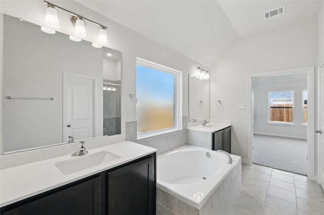 bathroom featuring visible vents, a sink, a shower stall, a bath, and vaulted ceiling