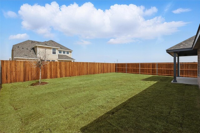 view of yard with a fenced backyard