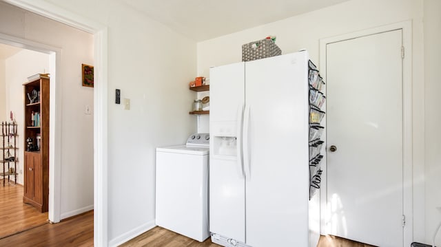 laundry area with washer / dryer and hardwood / wood-style flooring