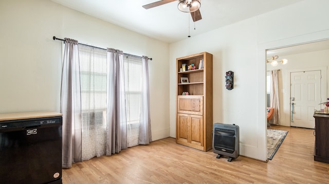 interior space with heating unit, ceiling fan, and light hardwood / wood-style floors