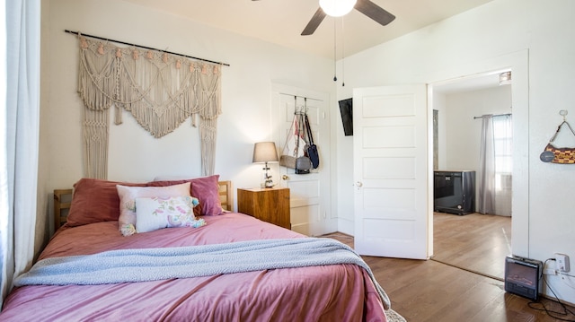 bedroom with ceiling fan, hardwood / wood-style floors, and a closet