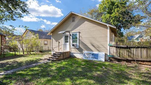 back of house featuring a yard