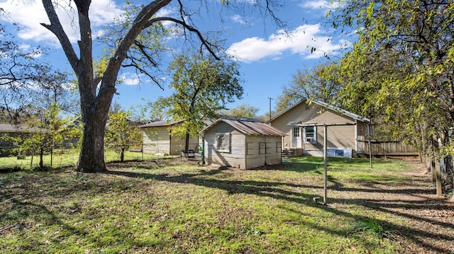 exterior space with a lawn and a storage unit