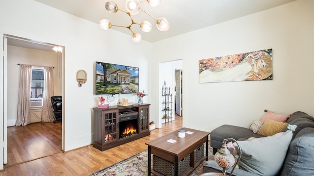 living room featuring an inviting chandelier and wood-type flooring