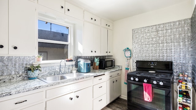 kitchen with white cabinets, dark hardwood / wood-style flooring, decorative backsplash, sink, and black range with gas stovetop