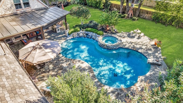 view of swimming pool with a yard, a patio, and an in ground hot tub