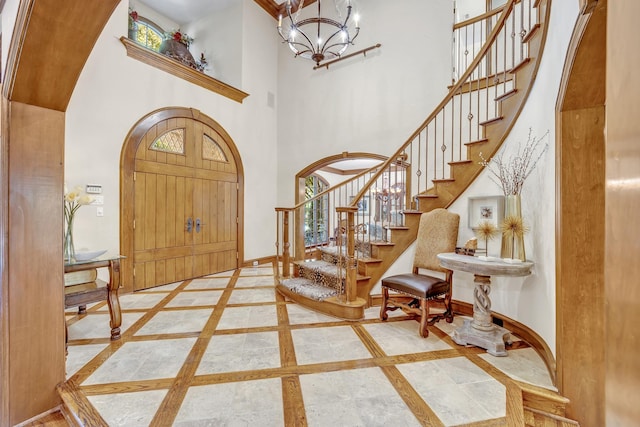 entrance foyer with an inviting chandelier and a towering ceiling