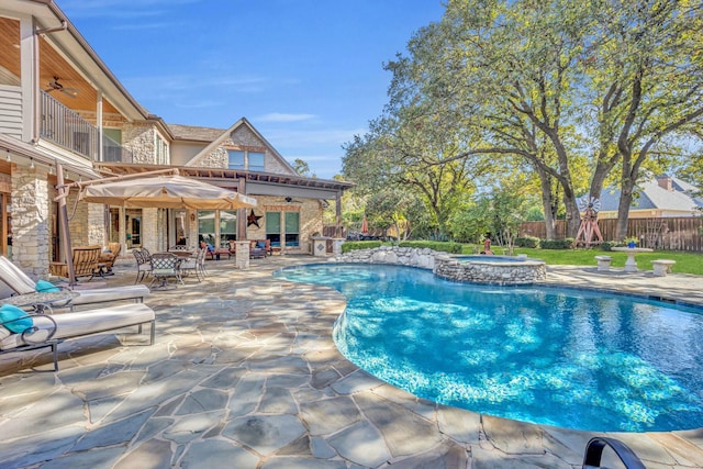 view of pool with ceiling fan, a patio area, and an in ground hot tub