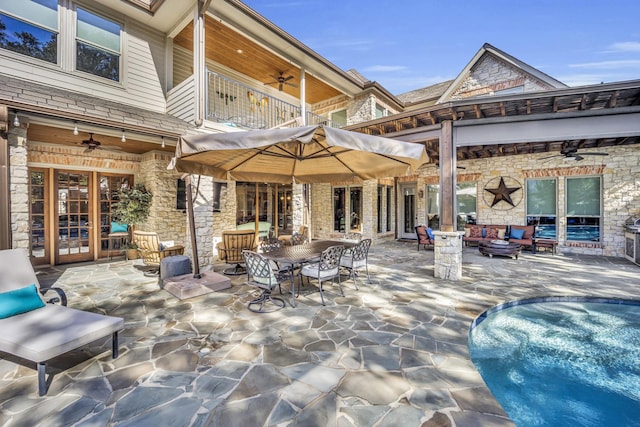 view of patio / terrace with ceiling fan, an outdoor hangout area, and a balcony