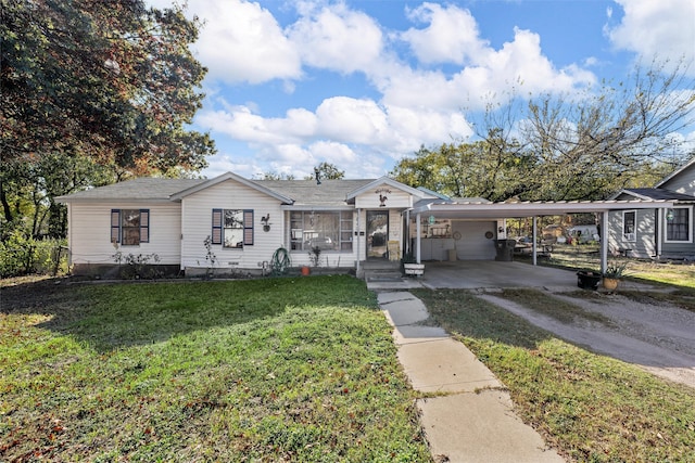 view of front of house featuring a carport, a porch, and a front yard