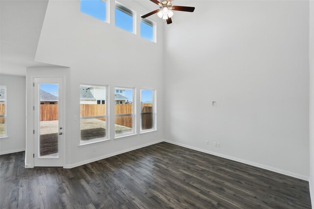 5036 Water Lily Ln, Fort Worth, TX 76036 - unfurnished living room featuring baseboards, dark wood-type flooring, and a healthy amount of sunlight