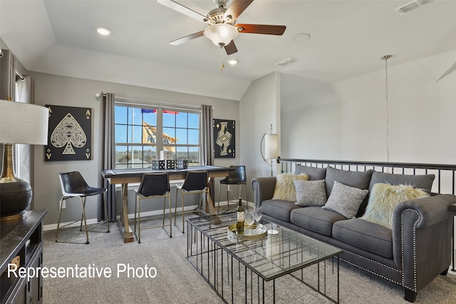 living room featuring ceiling fan, light colored carpet, and lofted ceiling