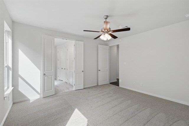 carpeted living room with ceiling fan