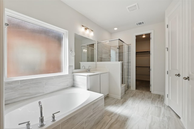 5036 Water Lily Ln, Fort Worth, TX 76036 - full bath with visible vents, a walk in closet, a stall shower, a bath, and vanity