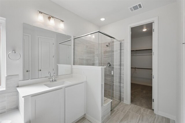 5036 Water Lily Ln, Fort Worth, TX 76036 - full bathroom featuring visible vents, vanity, a spacious closet, and a shower stall