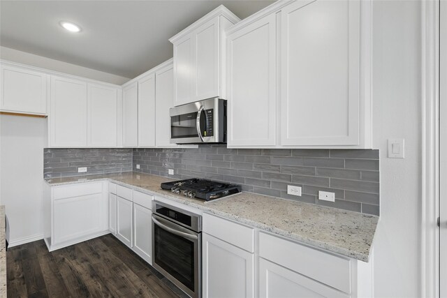 5036 Water Lily Ln, Fort Worth, TX 76036 - kitchen with dark wood-type flooring, light stone counters, backsplash, white cabinetry, and stainless steel appliances