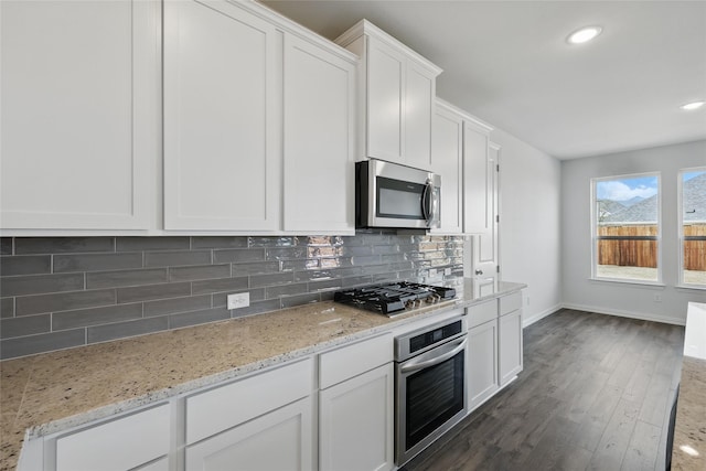 5036 Water Lily Ln, Fort Worth, TX 76036 - kitchen featuring light stone countertops, decorative backsplash, white cabinets, stainless steel appliances, and dark wood-style flooring