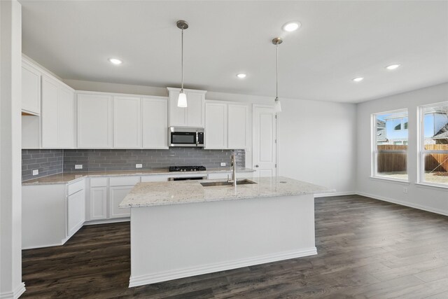 5036 Water Lily Ln, Fort Worth, TX 76036 - kitchen with a sink, stainless steel microwave, dark wood-type flooring, and tasteful backsplash