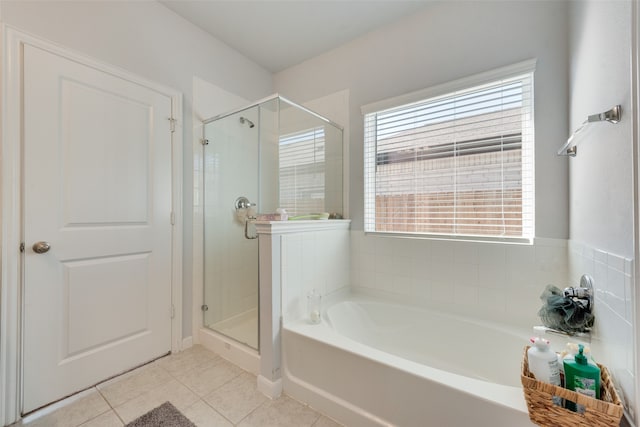 bathroom with shower with separate bathtub and tile patterned floors