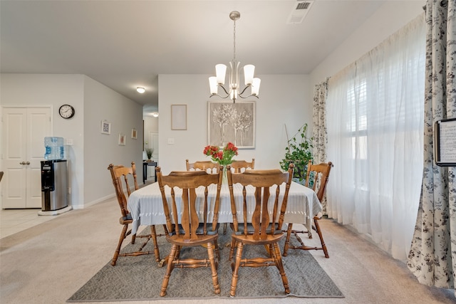 carpeted dining space with a chandelier