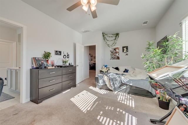 bedroom with ceiling fan and light carpet