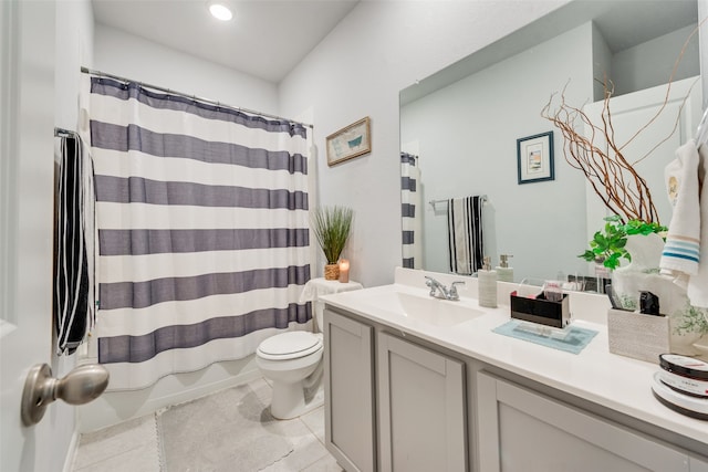 bathroom with tile patterned flooring, vanity, and toilet