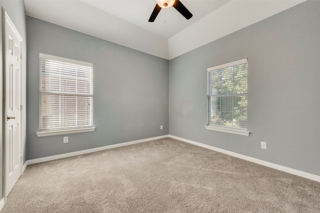 carpeted spare room featuring ceiling fan