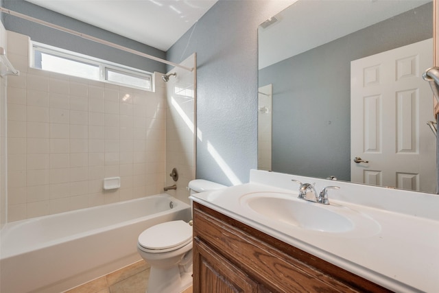 full bathroom with tile patterned flooring, vanity, toilet, and tiled shower / bath combo