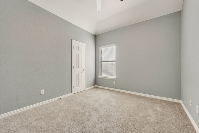 spare room with ceiling fan and carpet