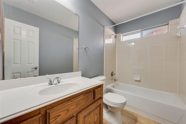 full bathroom with tile patterned flooring, vanity, toilet, and tiled shower / bath