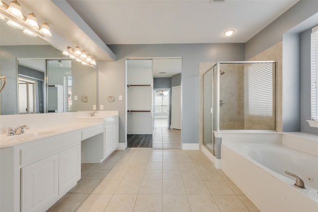 bathroom featuring tile patterned flooring, vanity, and plus walk in shower