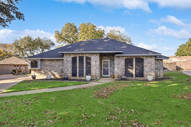 view of front of house with a garage and a front yard