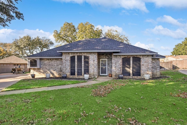 view of front of property featuring a garage and a front yard