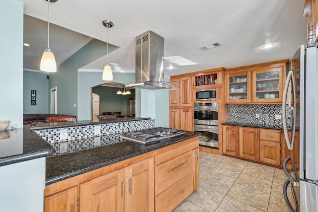 kitchen featuring dark stone counters, pendant lighting, island exhaust hood, stainless steel appliances, and backsplash