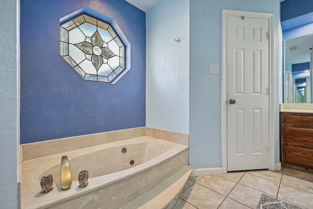 bathroom with vanity, tile patterned flooring, and a bathtub