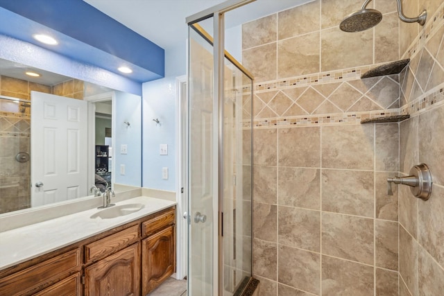 bathroom featuring vanity and a shower with shower door