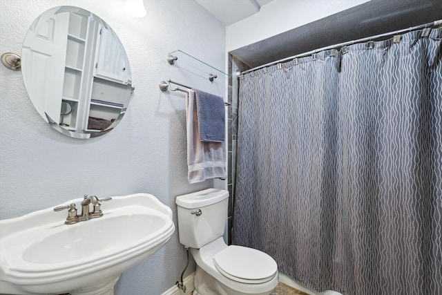 bathroom with sink, toilet, and walk in shower