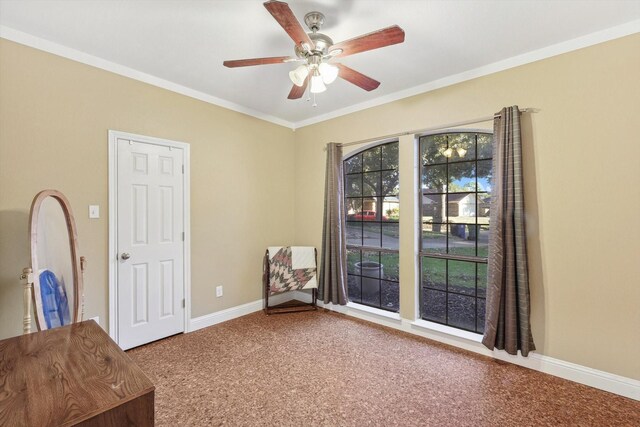 unfurnished room featuring crown molding, carpet floors, and ceiling fan