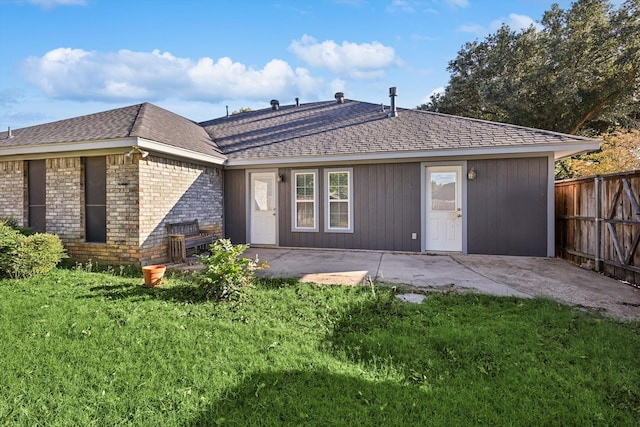 rear view of house with a patio area and a lawn