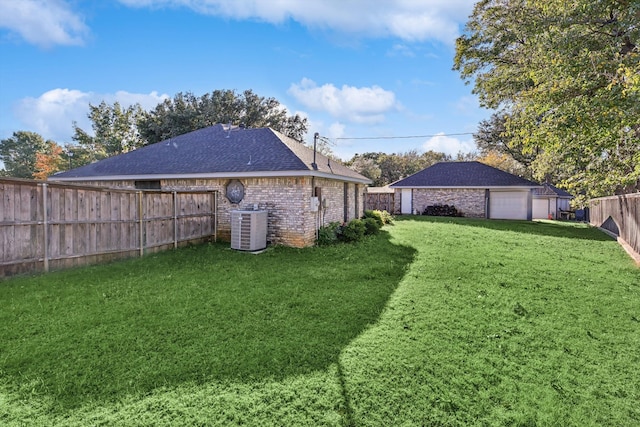 view of yard featuring a garage and central air condition unit