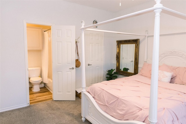 carpeted bedroom featuring ensuite bath