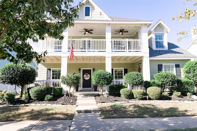 view of front facade with ceiling fan and a balcony