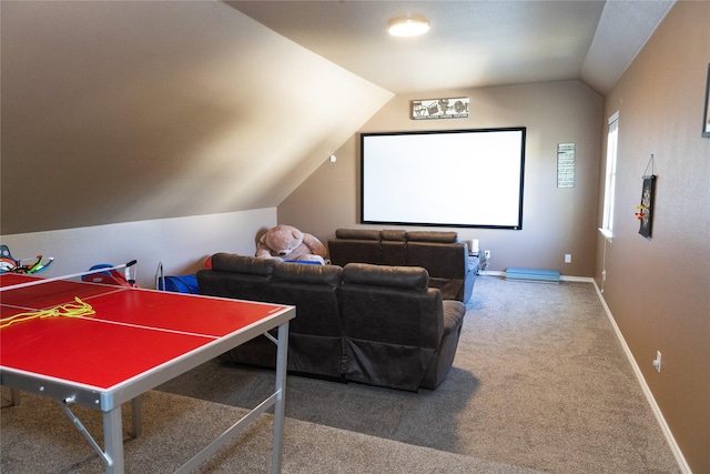 carpeted cinema room featuring vaulted ceiling